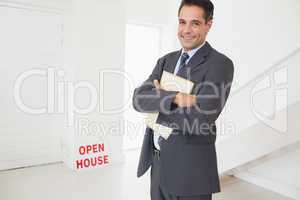 Businessman with documents at an house for sale