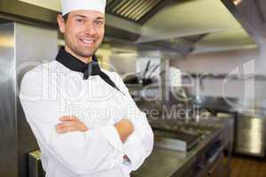 Smiling male cook with arms crossed in the kitchen