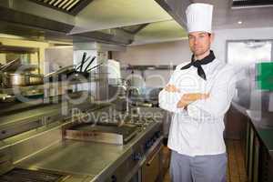 Serious male cook with arms crossed in the kitchen