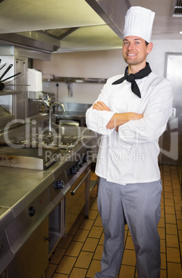 Smiling male cook with arms crossed in the kitchen