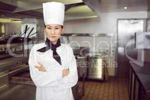 Portrait of confident female cook in kitchen