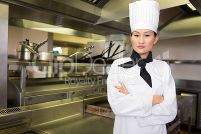 Portrait of confident female cook in kitchen