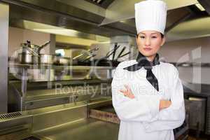 Portrait of confident female cook in kitchen