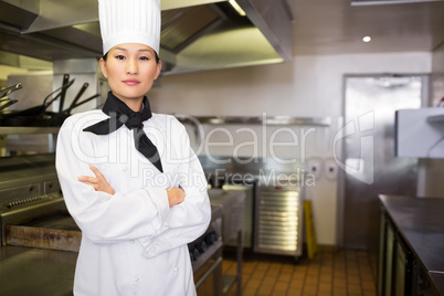 Portrait of confident female cook in kitchen