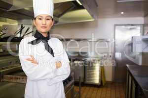 Portrait of confident female cook in kitchen