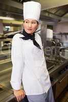 Side view of thoughtful female cook in kitchen