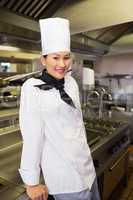 Smiling female cook in kitchen