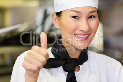 Portrait of smiling female cook gesturing thumbs up