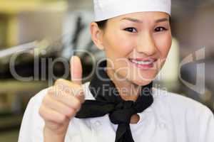 Portrait of smiling female cook gesturing thumbs up