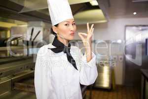 Smiling female cook in the kitchen