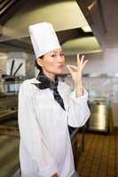 Smiling female cook in the kitchen