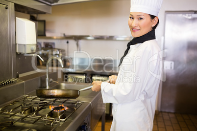 Female cook preparing food in kitchen