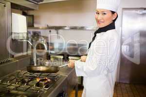 Female cook preparing food in kitchen