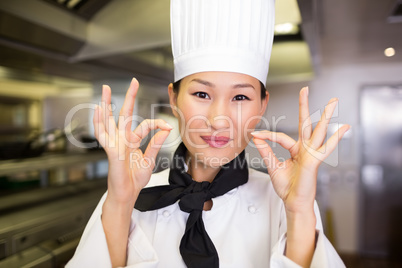 Closeup of a smiling female cook gesturing okay sign