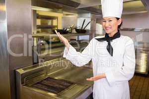 Portrait of a smiling female cook in kitchen