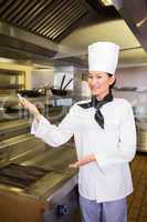 Portrait of a smiling female cook in kitchen