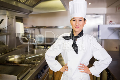 Portrait of smiling female cook in kitchen