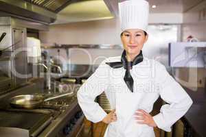 Portrait of smiling female cook in kitchen