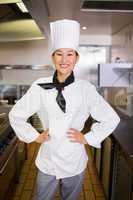 Portrait of smiling female cook in kitchen