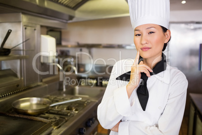 Portrait of confident female cook in kitchen