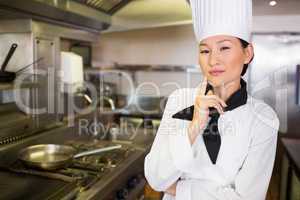 Portrait of confident female cook in kitchen