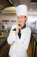 Portrait of thoughtful female cook in kitchen