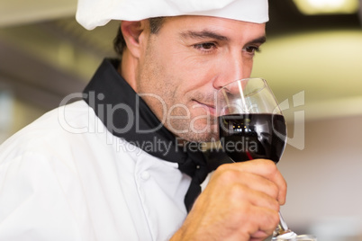 Closeup of a male chef smelling red wine