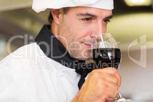 Closeup of a male chef smelling red wine