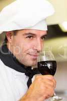 Closeup of a male chef smelling red wine