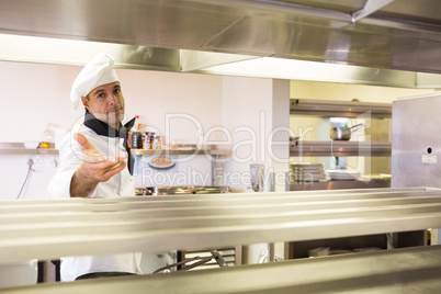 Confident male chef standing in kitchen