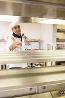 Portrait of a confident male chef in kitchen