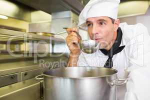 Male cook tasting food in kitchen