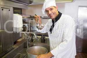 Smiling chef preparing food in the kitchen