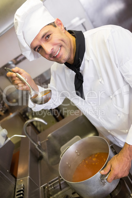 Smiling male chef preparing food in the kitchen