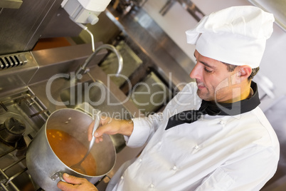 Concentrated chef preparing food in the kitchen