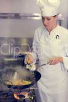 Female chef preparing food in kitchen