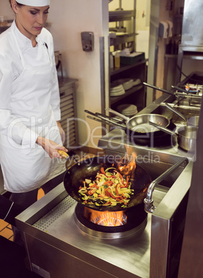 Female chef preparing food in kitchen