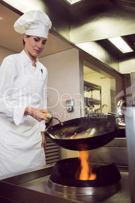 Female chef preparing food in kitchen