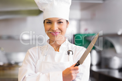 Portrait of a confident female cook holding knife