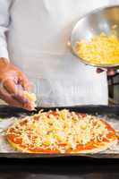 Mid section of a male chef preparing pizza