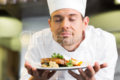 Closeup of a chef with eyes closed smelling food