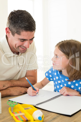 Father looking at daughter drawing