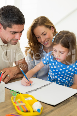 Parents assisting daughter in coloring