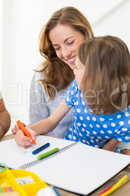 Mother with daughter coloring at home