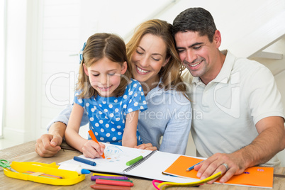 Parents looking at girl coloring