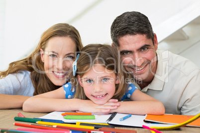 Family with book and crayons sitting at table