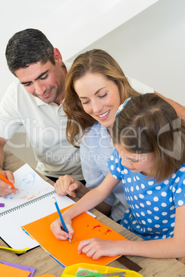 Parents looking at girl drawing