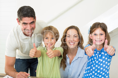 Happy family showing thumbs up