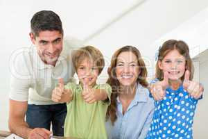 Happy family showing thumbs up