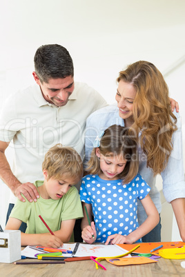 Parents looking at children coloring